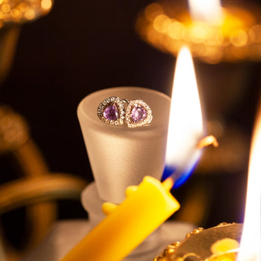 18k white gold stud earrings with natural alexandrite and diamond jackets, candlelit setting.